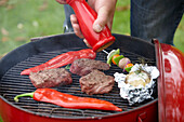 Grill with steaks and vegetables