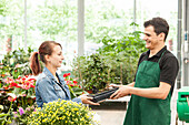 Garden centre salesman and customer