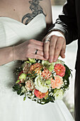 Bridal bouquet, hands with rings