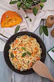 Spaghetti in creamy pumpkin sauce with sage and bacon