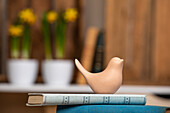 Ceramic bird on book