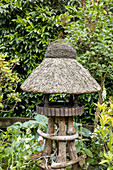 Birdhouse with thatched roof