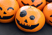 Pumpkin faces on mandarins