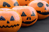 Pumpkin faces on mandarins