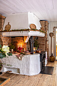 Cosy kitchen area with brick fireplace and Christmas decorations