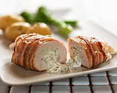 Chicken breast stuffed with cheese and herbs and wrapped in pancetta