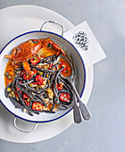 Black maccheroni al ferretto with blue crab