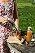 Preparing wild herb tea with rose petals