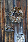 Weathered wreath on a wooden wall