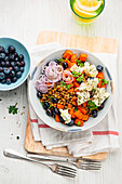 Lentil-sweet potato bowl with blue cheese and blueberries