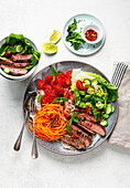 Rice noodle and vegetable bowl with beef steak