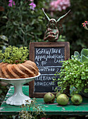 Garden cafe with chalkboard, bundt cake and green plant decoration