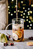 Christmas punch with oranges, cranberries and pears