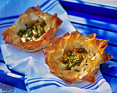 Crispy filo pastry tartlets with yoghurt and pistachio filling