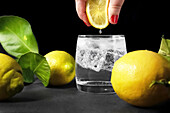 Squeeze lemon juice into a glass of water