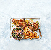 Honey-garlic pork chops, potato wedges and coleslaw