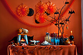 Halloween buffet with black bats, streamers and paper decorations