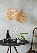 Decorative table with various vases and plants