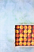 Peaches in a white wooden box