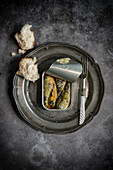 Open tin of sardines with bread