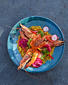 Grilled tiger prawns with saffron rice on a plate
