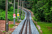 The Petit train de la Rhune rack railway, La Rhun mountain on the border with Spain, France. Train tracks of the historic funicular from 1924 up to the summit of La Rhune Mountain, 905m, Basque Country, Pyrenees