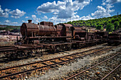 Old abandoned steam trains seen from the touristic train used for tourist trip through the RioTinto mining area, Huelva province, Spain.