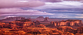Pastel sunrise panorama of Monument Valley with cloudy skies, from Hunt's Mesa. Monument Navajo Valley Tribal Park, Arizona.