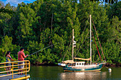 Fishers and sailing Boat in Puerto Barillas in Jiquilisco Bay in Gulf of Fonseca Pacific Ocean El Salvador Central America.