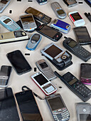 Assorted old celular phones in display window