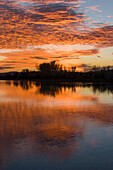 Colorful sunset skies reflected in the Green River near Jensen, Utah.