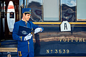 Staff of Belmond Venice Simplon Orient Express luxury train stoped at Venezia Santa Lucia railway station the central railway station in Venice Italy.