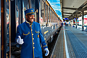 Staff of Belmond Venice Simplon Orient Express luxury train stoped at Innsbruck Hauptbahnhof train station railway station the central railway station in Innsbruck Austria.