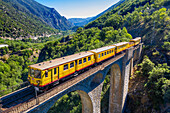 Aerial view of The Yellow Train or Train Jaune on Sejourne bridge - France, Pyrenees-Orientales.