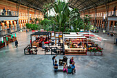 Greenhouse in Principal Hall. Bars and restaurants in Atocha train station in Madrid, Spain.