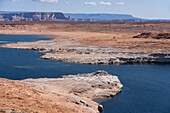 Bleached sandstone shows the former high water mark in Lake Powell. Glen Canyon National Recreation Area, Arizona. Due to drought, the lake was down 179 feet when this photo was taken.