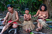 Women knitting clothes Yagua Indians living a traditional life near the Amazonian city of Iquitos, Peru.
