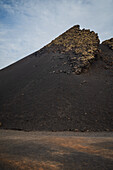 Volcan del Cuervo (Crow volcano) a crater explored by a loop trail in a barren, rock-strewn landscape