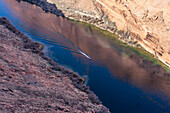 A powerboat on the Colorado River in Glen Canyon below the Glen Canyon Dam. Glen Canyon National Recreation Area, Arizona.