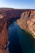 Glen Canyon & Colorado River unterhalb des Glen Canyon Damms mit Page, Arizona dahinter. Glen Canyon NRA. Man beachte die unterhalb des Damms vertäuten Arbeitsboote.