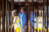 Passengers inside of Belmond Venice Simplon Orient Express luxury train running in Dolomites scenery. Belmond Venice Simplon Orient Express luxury train.