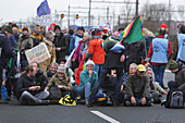 Extinction Rebellion climate activists gather to block the main highway A10 in front of the former headquarters of Dutch multinational bank on December 30, 2023 in Amsterdam,Netherlands. Environmental protectors of Extinction Rebellion make a demonstration against ING bank to protest its financing of fossil fuels.