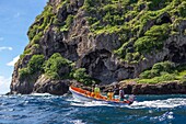 Martinique, below the rock of the diamond a yole motorboat typical of the Caribbean, with on board 4 fishermen