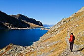 France, Isere, La Ferriere, hiker at lake Cottepens