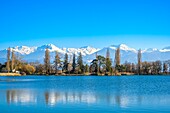 France, Savoie, Les Marches, Lake Saint André in the heart of the Combe de Savoie vineyards, Belledonne range covered with snow in the background