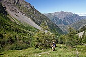 France, Isere, Lavaldens, Female hiker on the path toward Rif bruyant lake