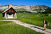 France, Haute Savoie, Le La Balme de Thuy, hiker at the Notre-Dame-des-Neiges chapel