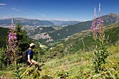 France, Isere, Valbonnais, Female hiker above the village on the Côte Belle crest