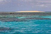 France, Mayotte island (French overseas department), Grande Terre, M'Tsamoudou, islet of white sand on the coral reef in the lagoon facing Saziley Point, fisherman in dugout