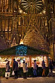 France, Bas Rhin, Strasbourg, old town listed as World Heritage by UNESCO, Christmas Market (Christkindelsmarik) stall place de la Cathedrale and Notre Dame Cathedral